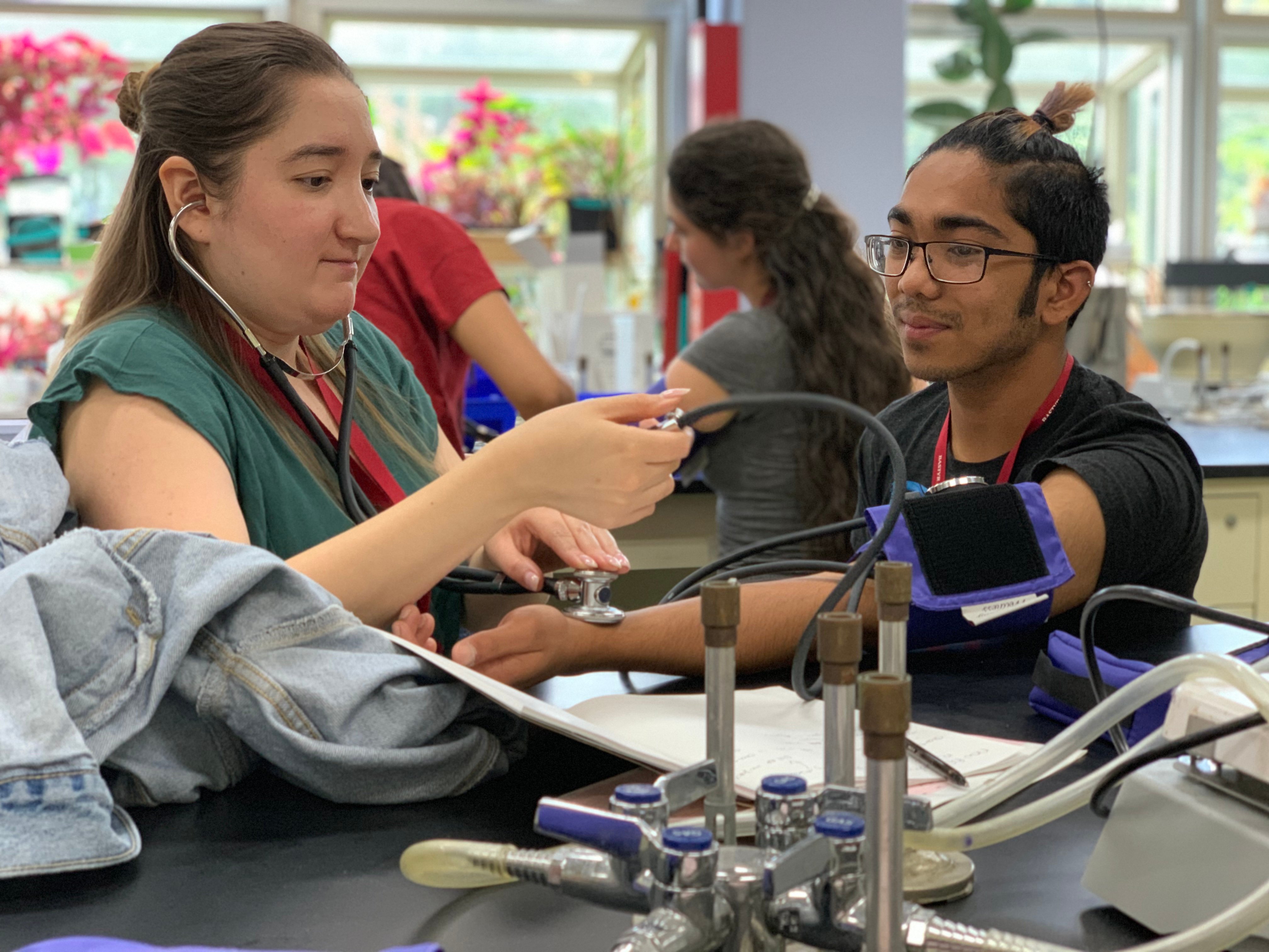 student taking blood pressure of another student