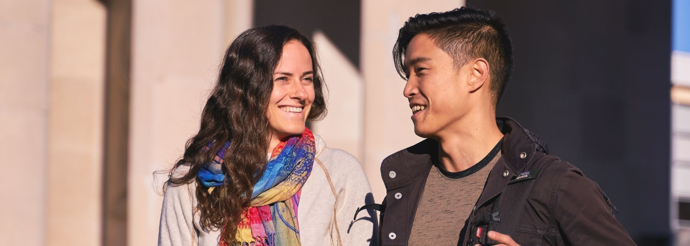 Page Banner - Two students talking and walking on campus