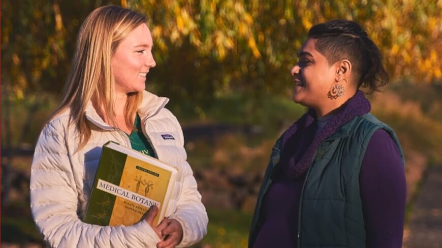 students converse in Bastyr University garden