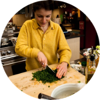 woman cutting what could be arugula-2