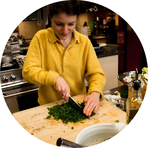 woman cutting what could be arugula
